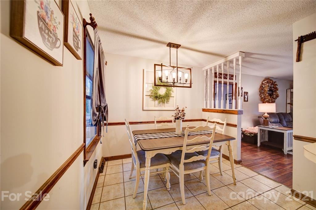411 Gulledge Parker Road Monroe, NC 28112 - Photo 3 of 29 a view of a dining room with furniture and a chandelier