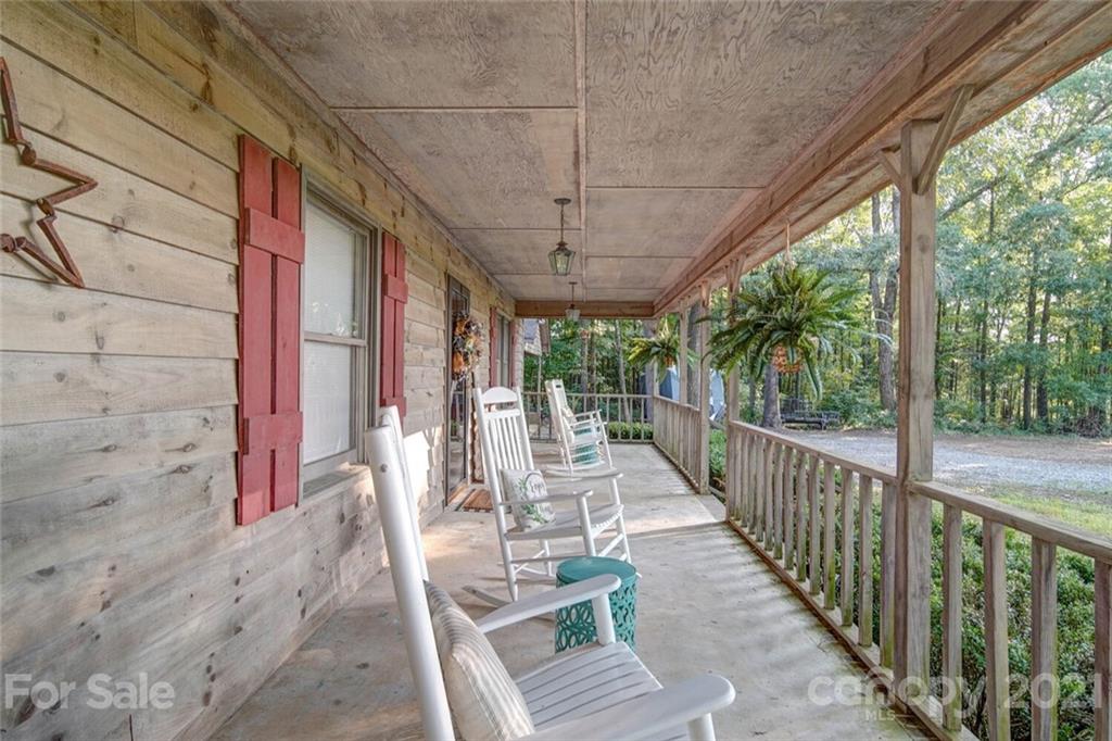 411 Gulledge Parker Road Monroe, NC 28112 - Photo 21 of 29 a view of a chairs and table in patio with wooden floor