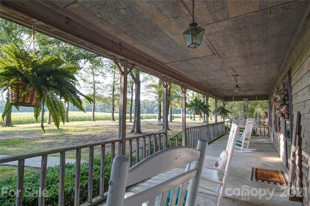 411 Gulledge Parker Road Monroe, NC 28112 - Photo 24 of 29 a view of a porch with furniture and wooden floor