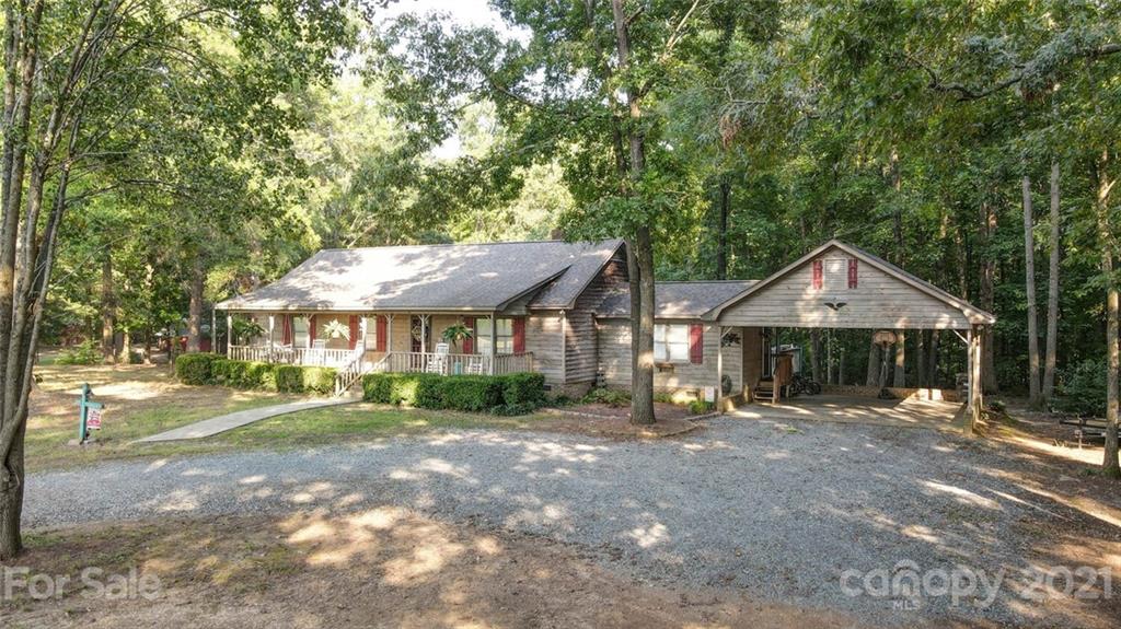411 Gulledge Parker Road Monroe, NC 28112 - Photo 28 of 29 a front view of a house with a yard and potted plants