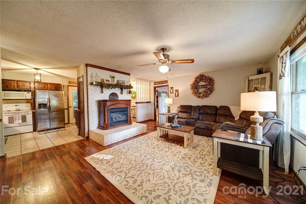 411 Gulledge Parker Road Monroe, NC 28112 - Photo 4 of 29 a living room with furniture and a fireplace