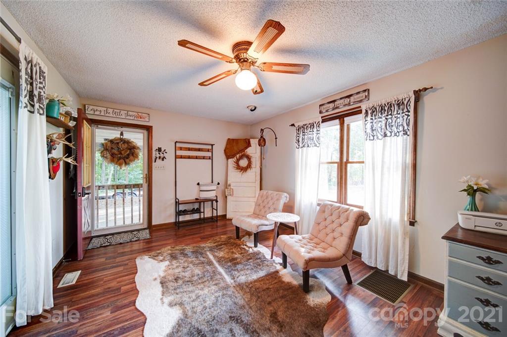 411 Gulledge Parker Road Monroe, NC 28112 - Photo 7 of 29 a living room with furniture a fireplace and a window