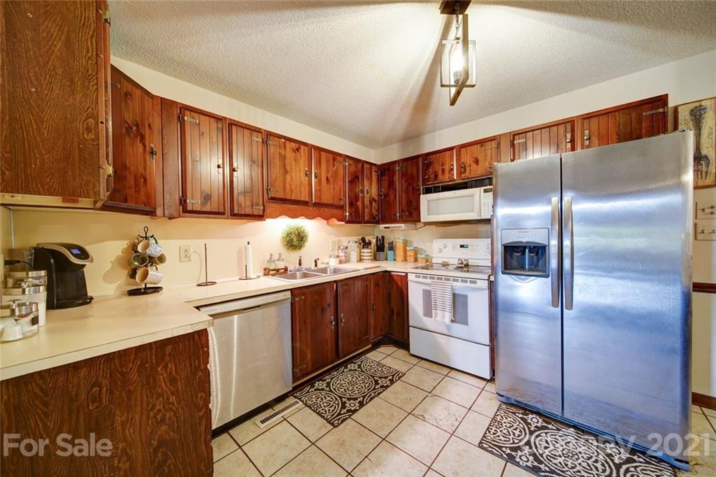 411 Gulledge Parker Road Monroe, NC 28112 - Photo 10 of 29 a kitchen with stainless steel appliances granite countertop a sink refrigerator and cabinets