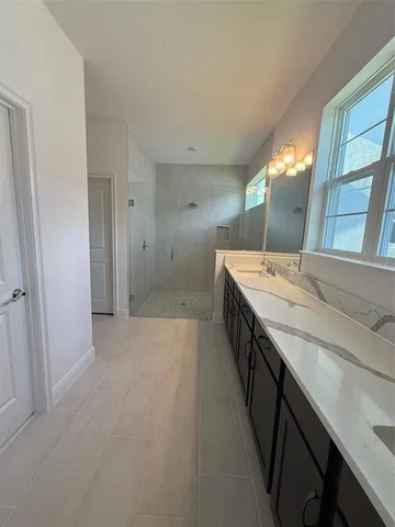 a bathroom with a double vanity sink and mirror