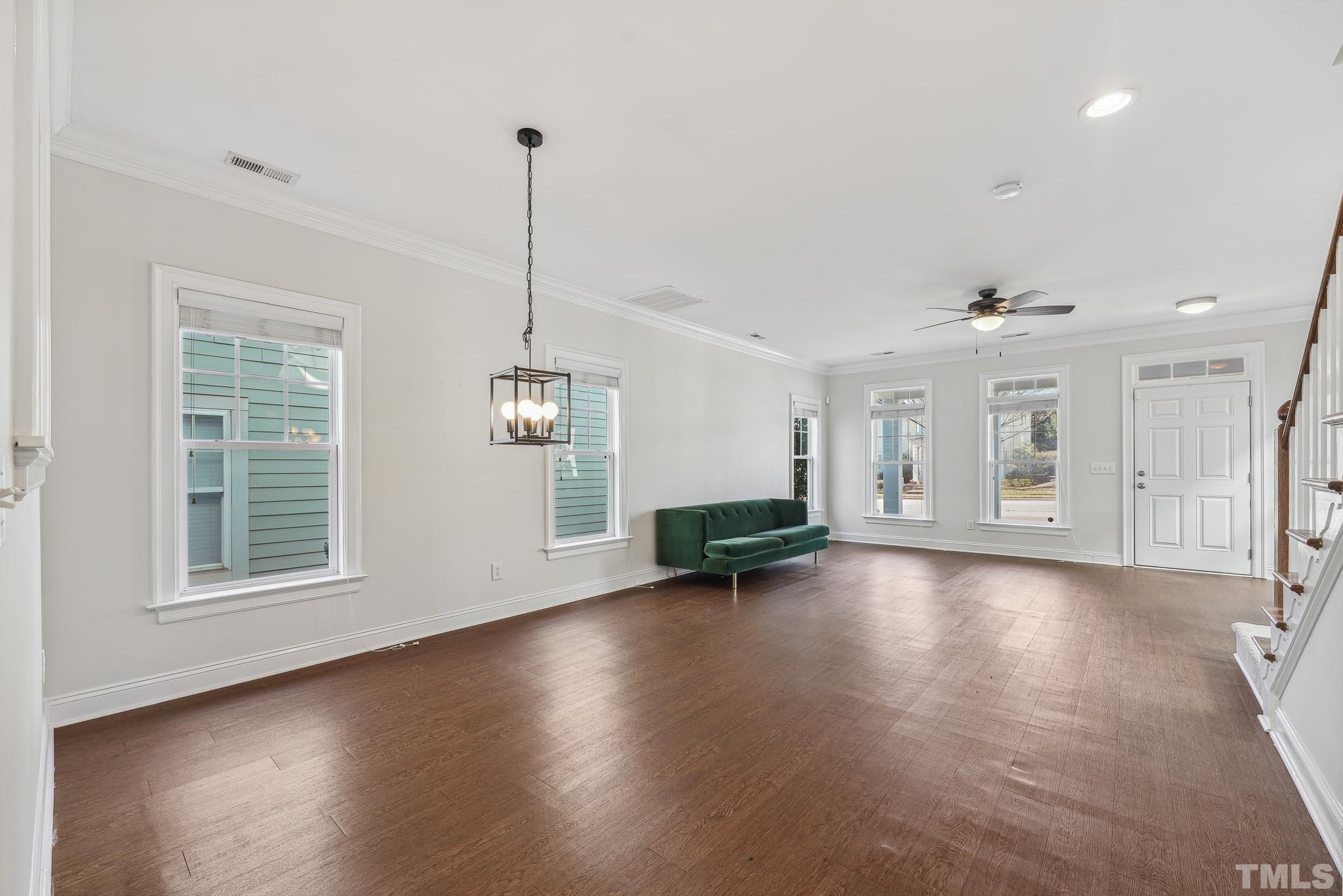7710 ACC Boulevard Raleigh, NC 27617 - Photo 11 of 33 an empty room with wooden floor and windows