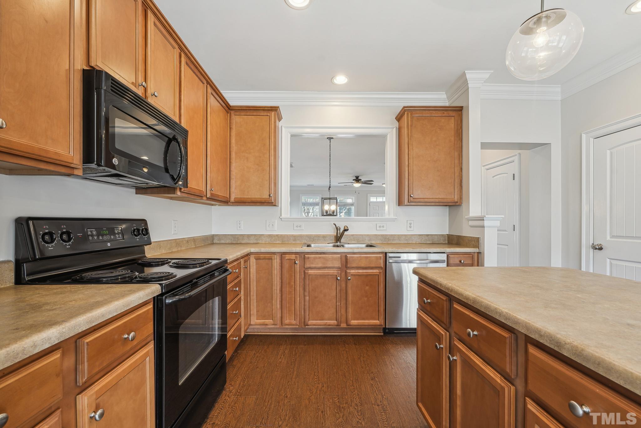 7710 ACC Boulevard Raleigh, NC 27617 - Photo 13 of 33 a kitchen with stainless steel appliances granite countertop a sink stove and microwave