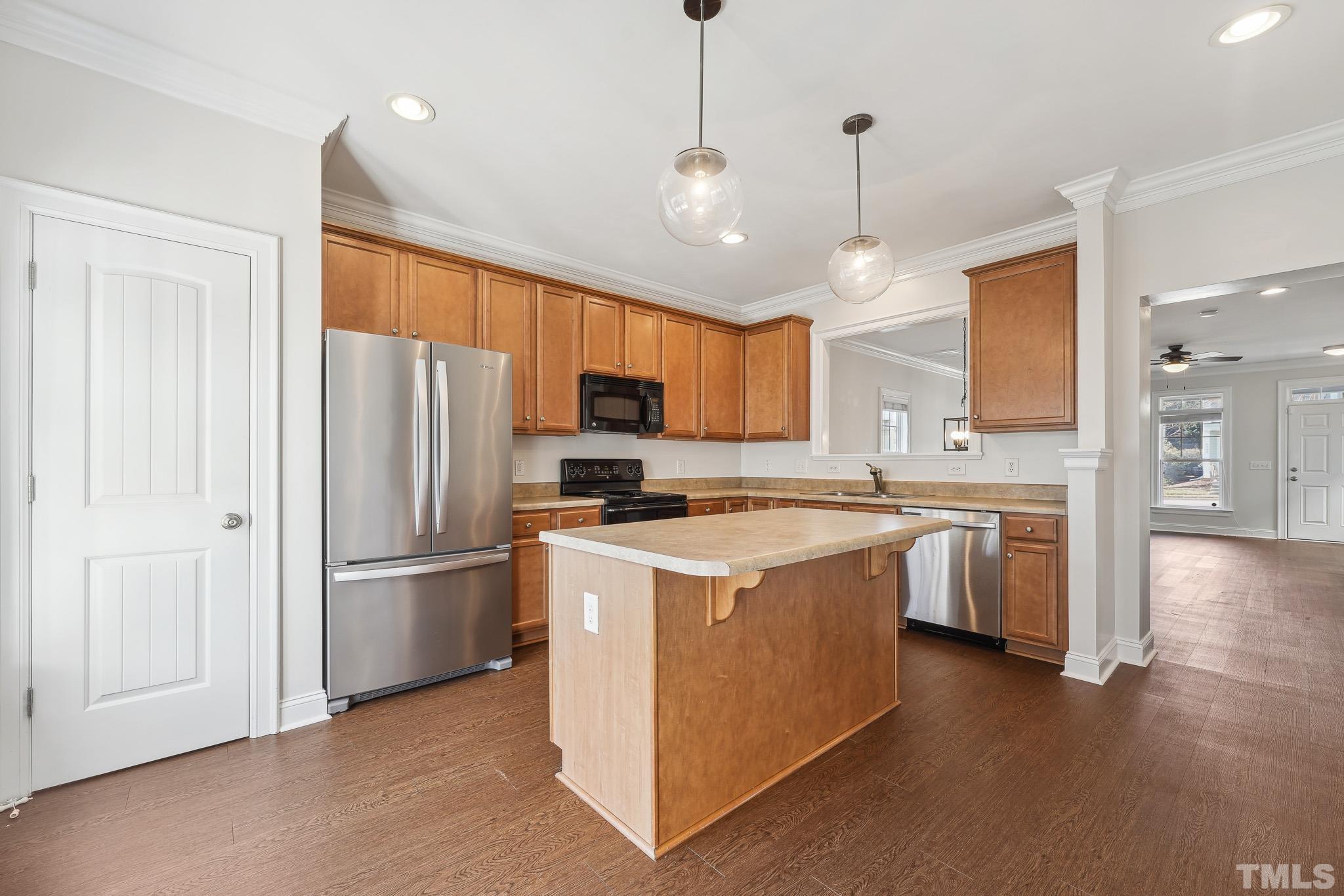 7710 ACC Boulevard Raleigh, NC 27617 - Photo 14 of 33 a kitchen with refrigerator cabinets and wooden floor