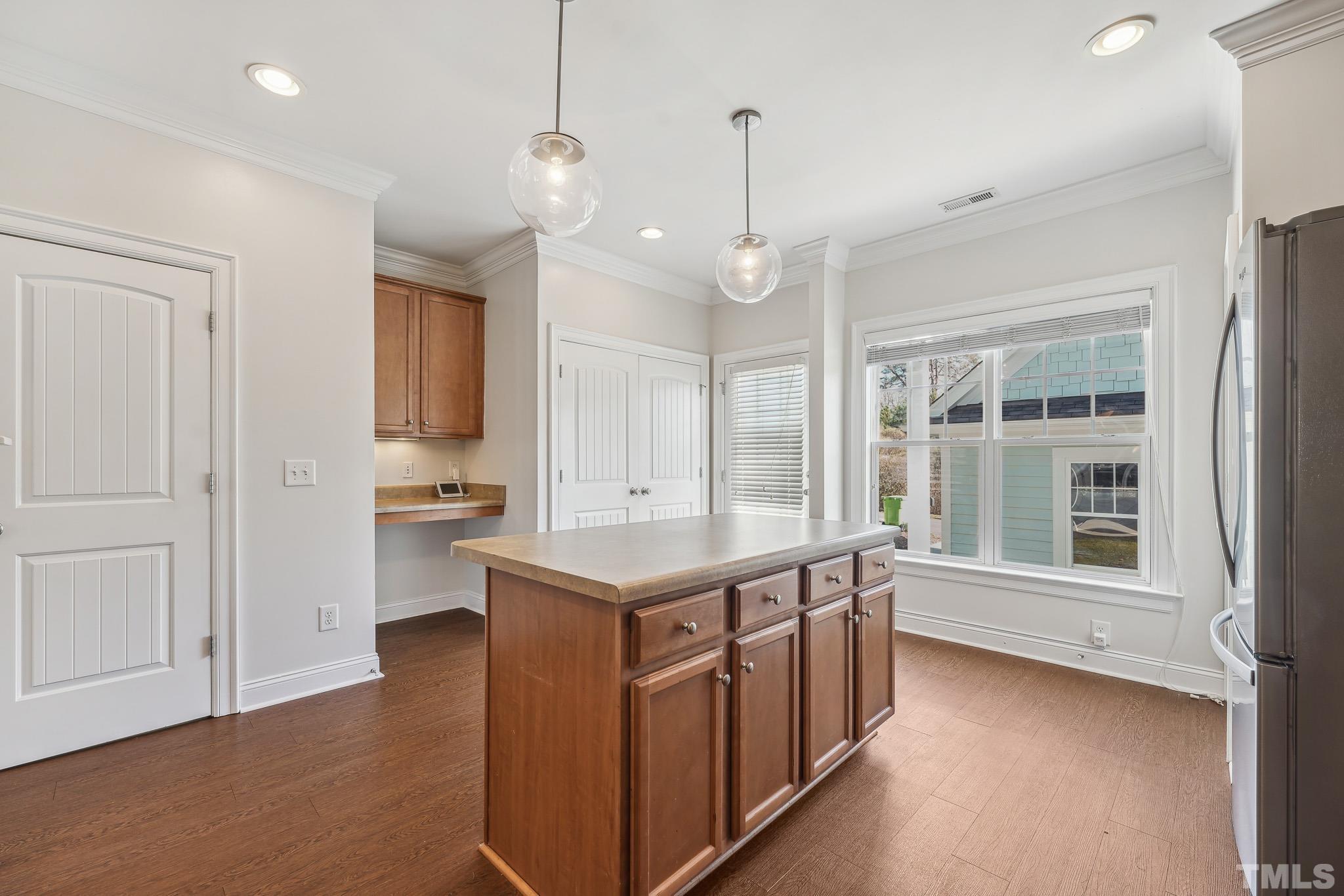 7710 ACC Boulevard Raleigh, NC 27617 - Photo 15 of 33 a kitchen that has a lot of cabinets and wooden floor
