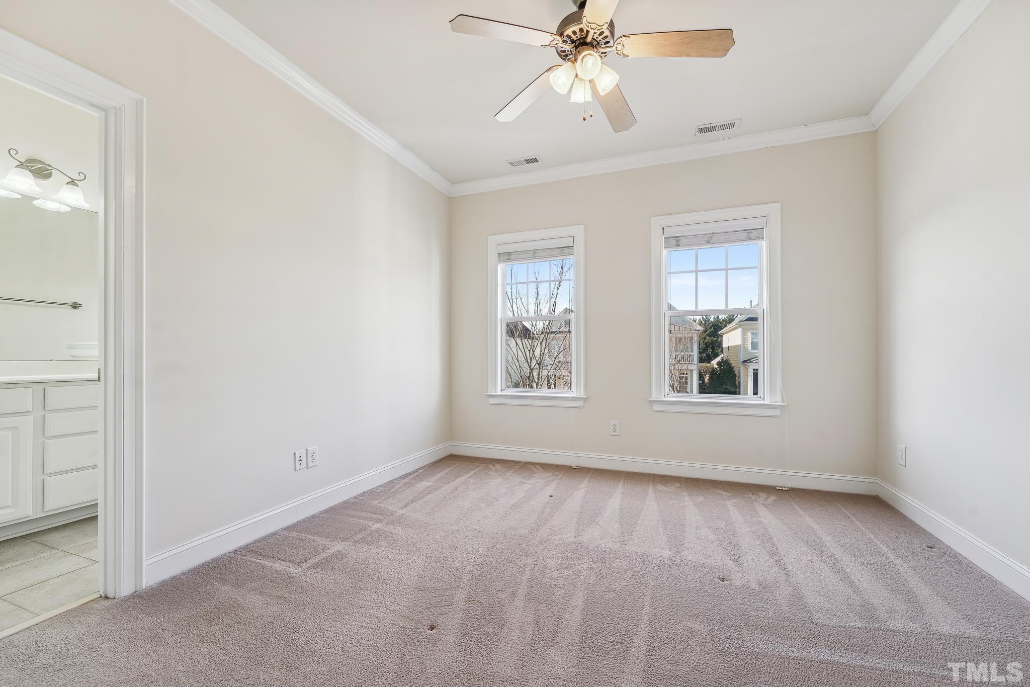 7710 ACC Boulevard Raleigh, NC 27617 - Photo 18 of 33 an empty room with windows and fan