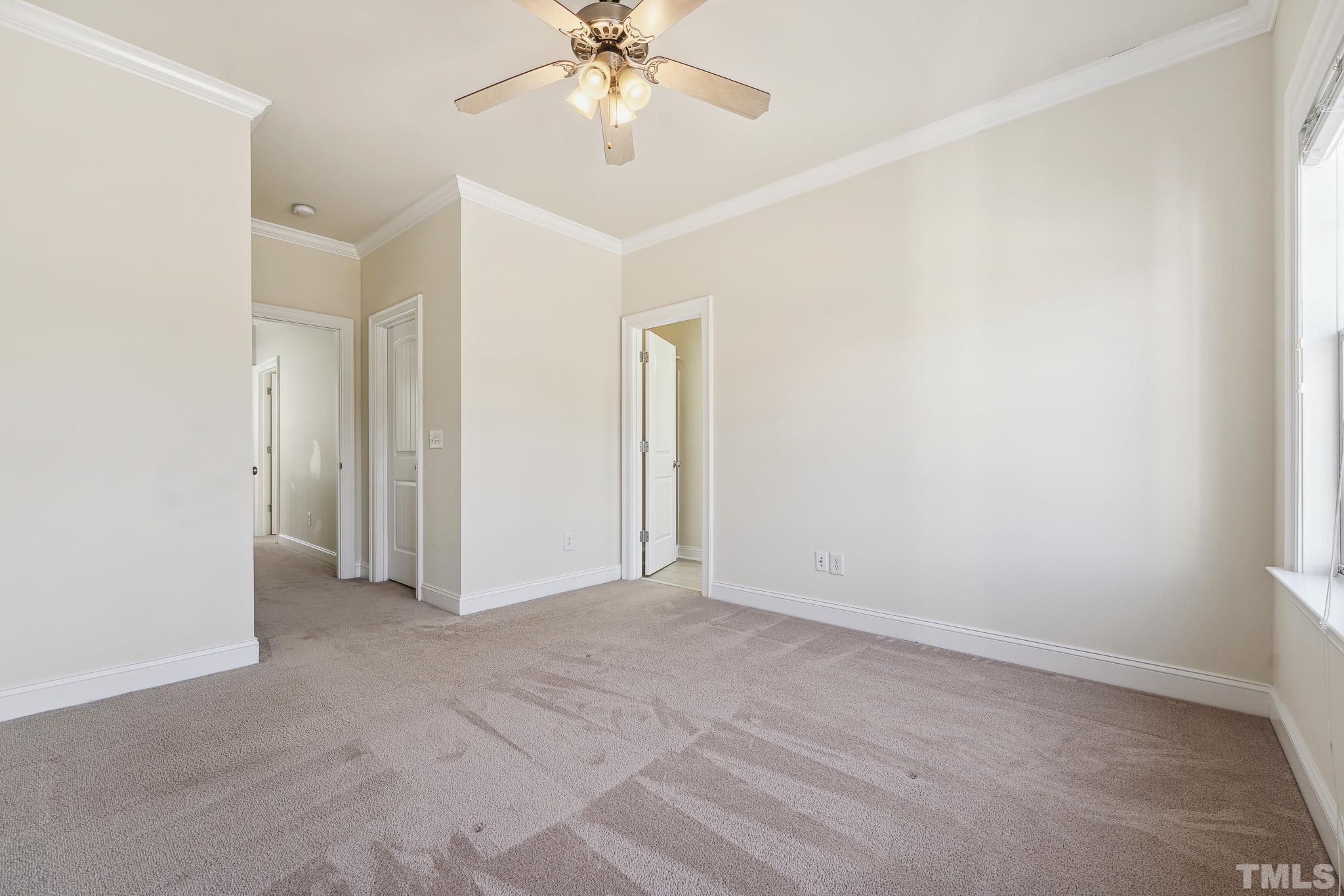 7710 ACC Boulevard Raleigh, NC 27617 - Photo 19 of 33 an empty room with a chandelier fan and closet