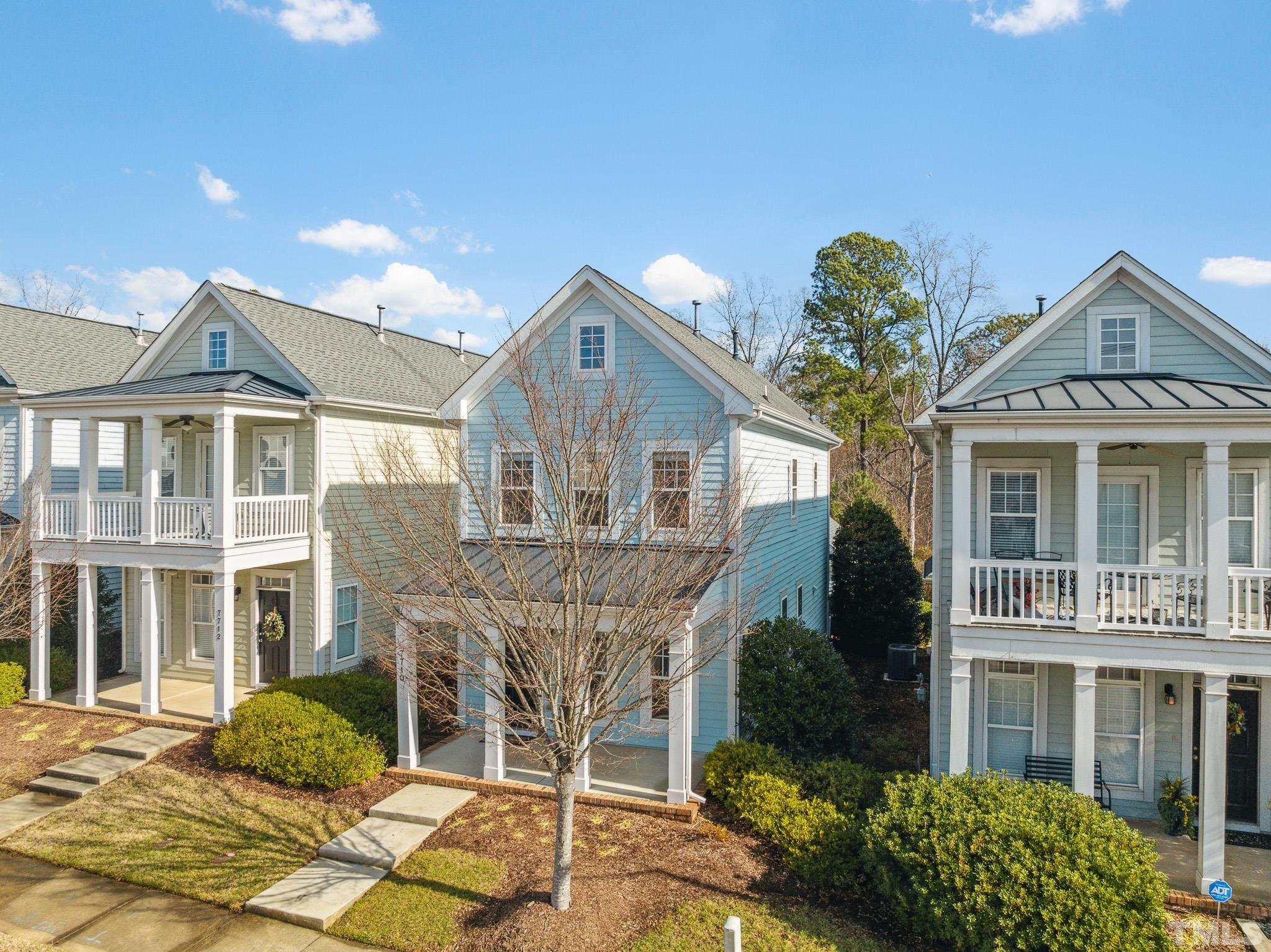 7710 ACC Boulevard Raleigh, NC 27617 - Photo 2 of 33 a front view of a house with a garden