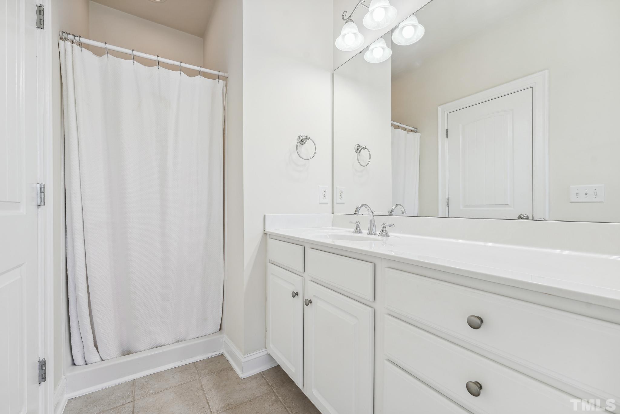 7710 ACC Boulevard Raleigh, NC 27617 - Photo 22 of 33 a bathroom with a sink and a mirror
