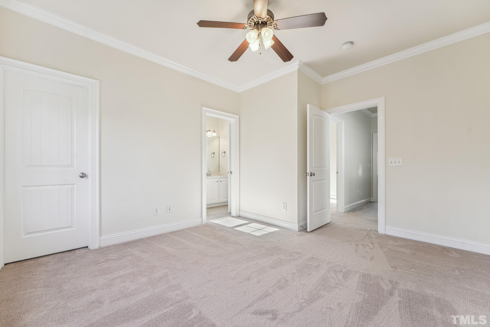 7710 ACC Boulevard Raleigh, NC 27617 - Photo 26 of 33 an empty room with closet and a chandelier fan