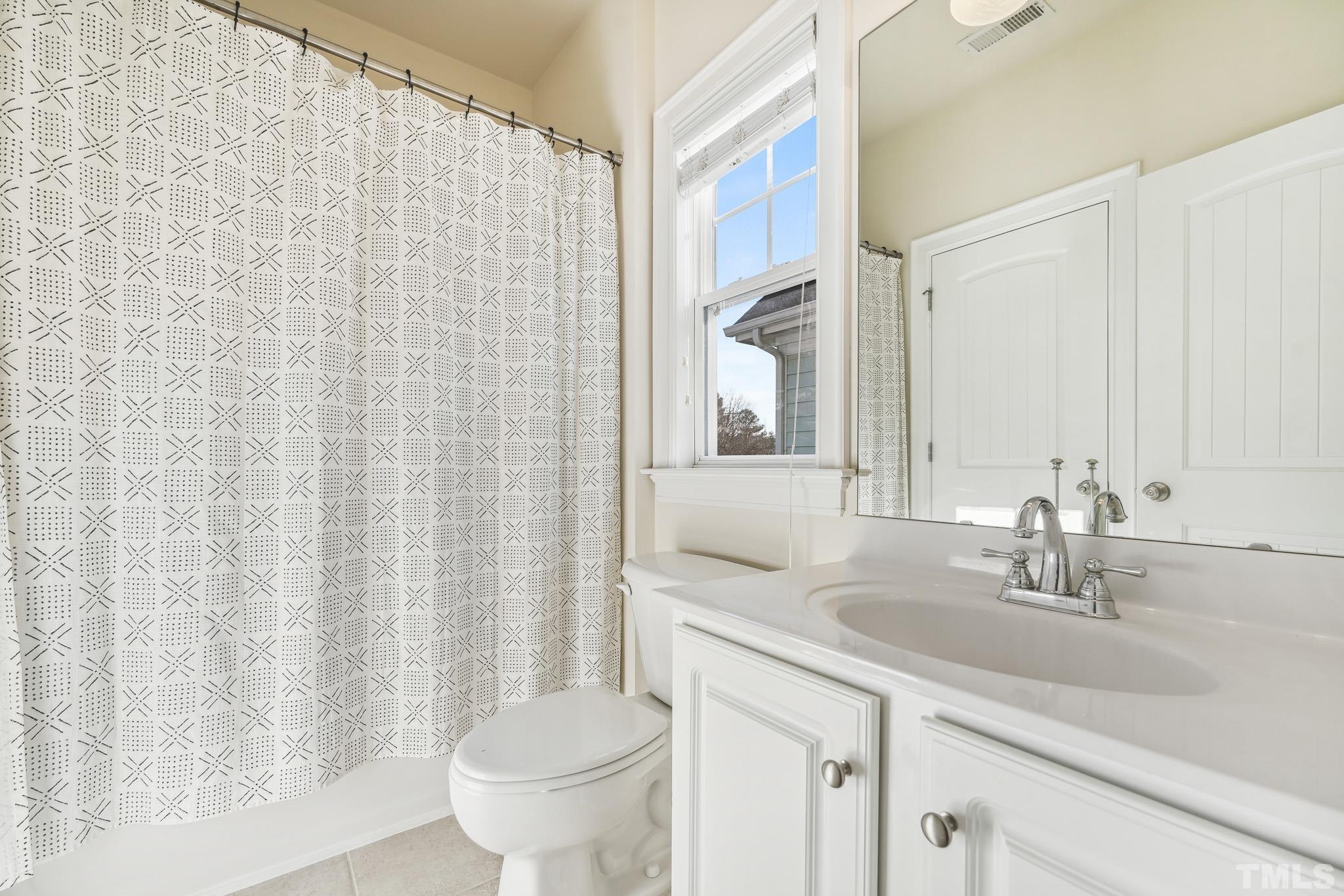 7710 ACC Boulevard Raleigh, NC 27617 - Photo 27 of 33 a bathroom with a sink a toilet and a mirror