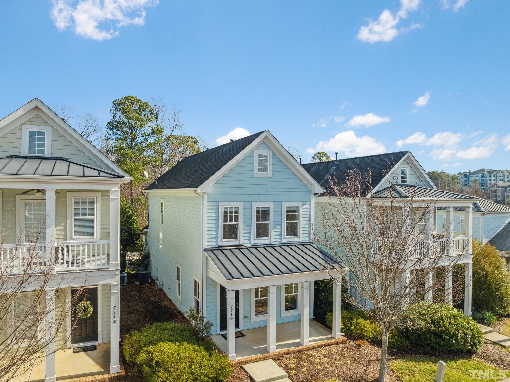 7710 ACC Boulevard Raleigh, NC 27617 - Photo 3 of 33 a front view of a house with a garden