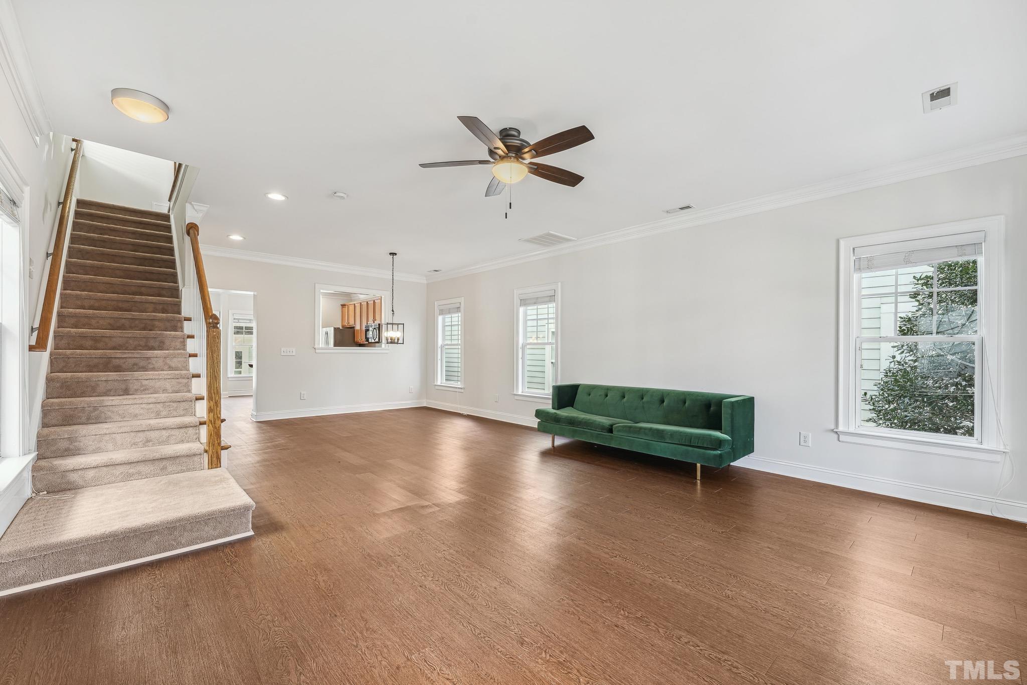 7710 ACC Boulevard Raleigh, NC 27617 - Photo 5 of 33 an empty room with windows and ceiling fan