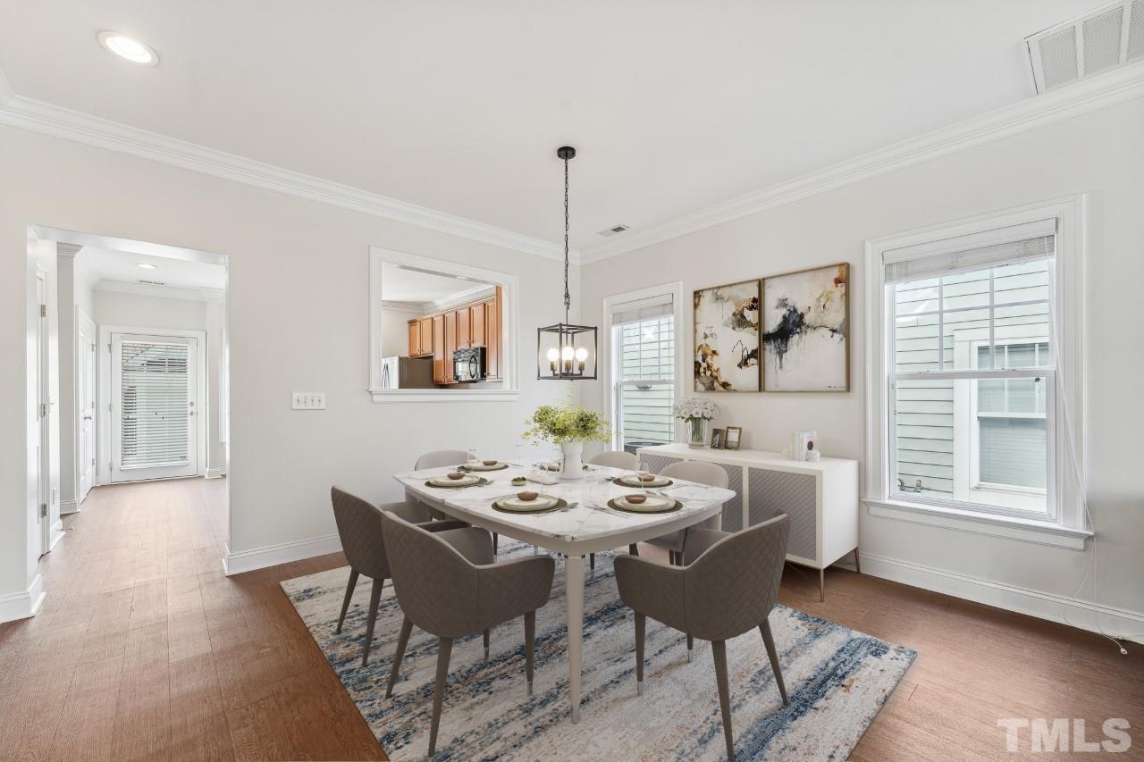 7710 ACC Boulevard Raleigh, NC 27617 - Photo 8 of 33 a dining room with furniture a rug and wooden floor
