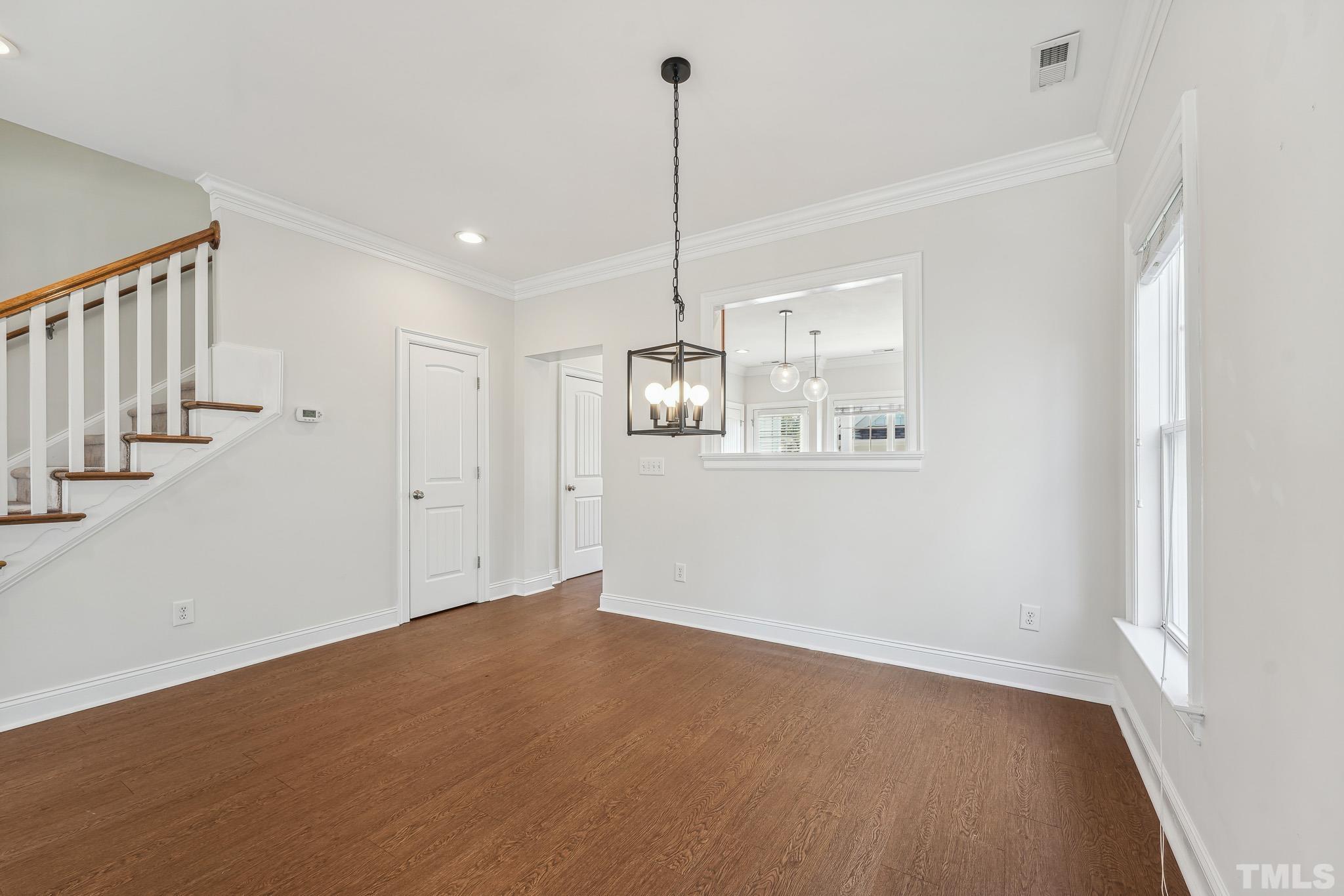7710 ACC Boulevard Raleigh, NC 27617 - Photo 10 of 33 a view of a room with wooden floor and an entryway