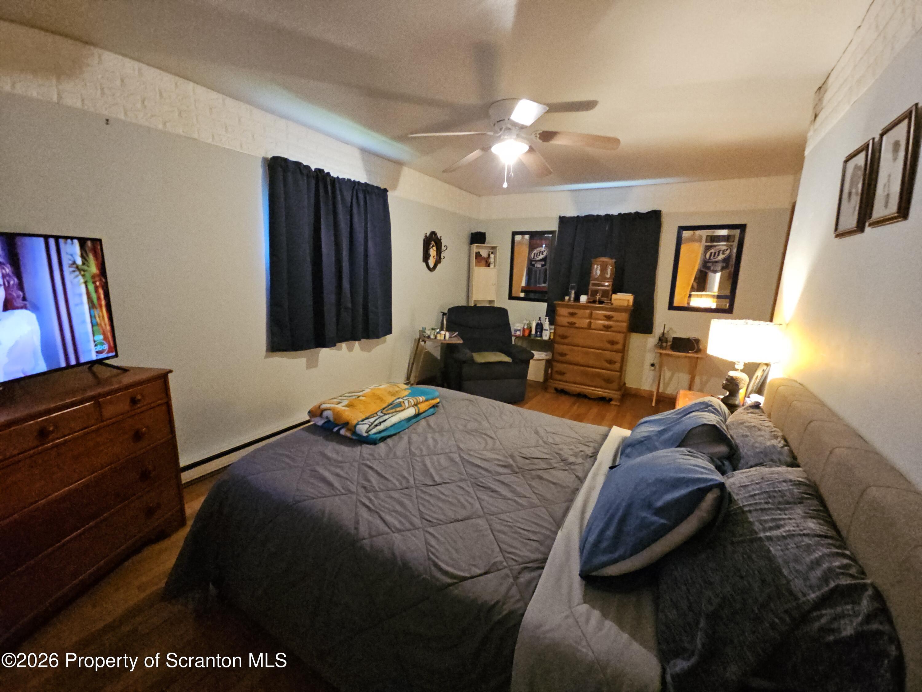 405 Baker Street Taylor, PA 18517 - Photo 24 of 36 a bedroom with a bed and wooden floor