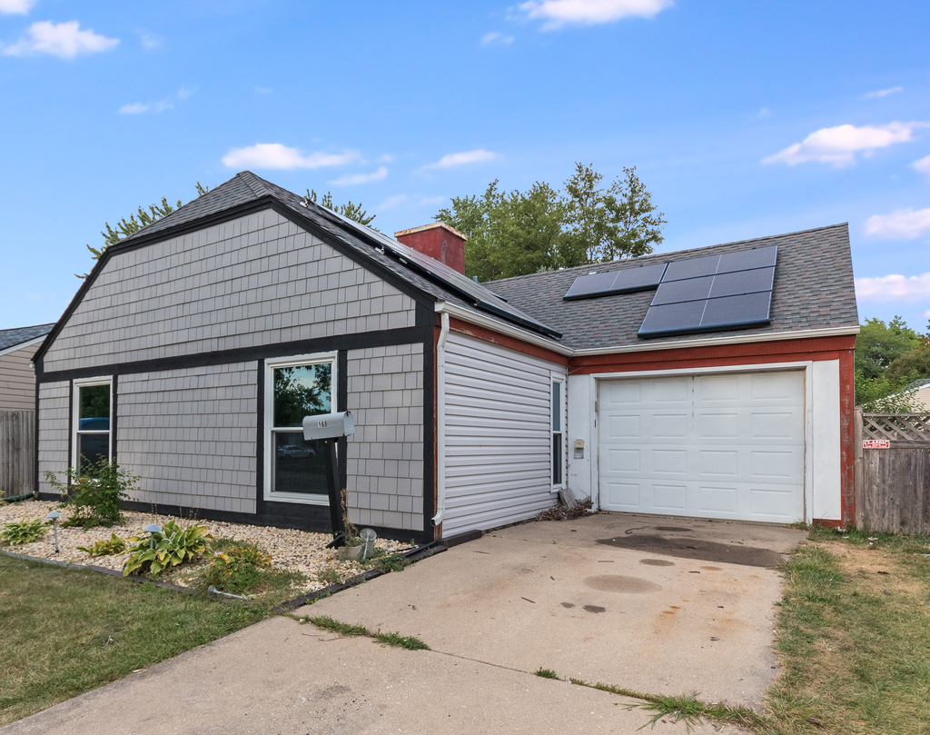 166 Heathgate Road Montgomery, IL 60538 - Photo 1 of 3 a front view of a house with a yard and garage