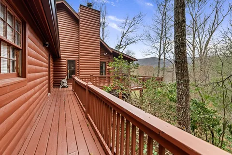 a backyard of a house with wooden floor outdoor seating and stainless steel appliances