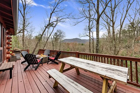 a backyard of a house with wooden stairs and deck