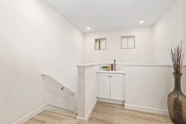 a view of entryway and hall with wooden floor