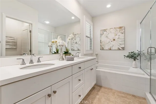 a bathroom with a bathtub a sink and a mirror