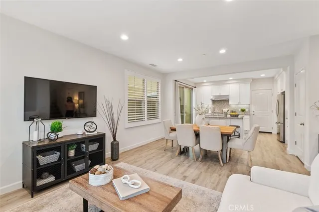a living room with furniture a window and a flat screen tv