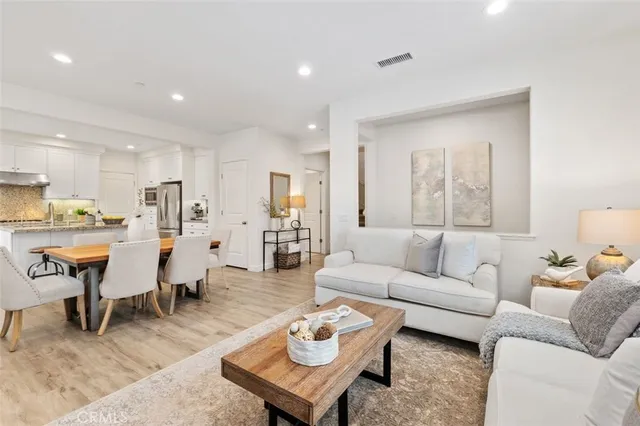 a living room with furniture kitchen and a table