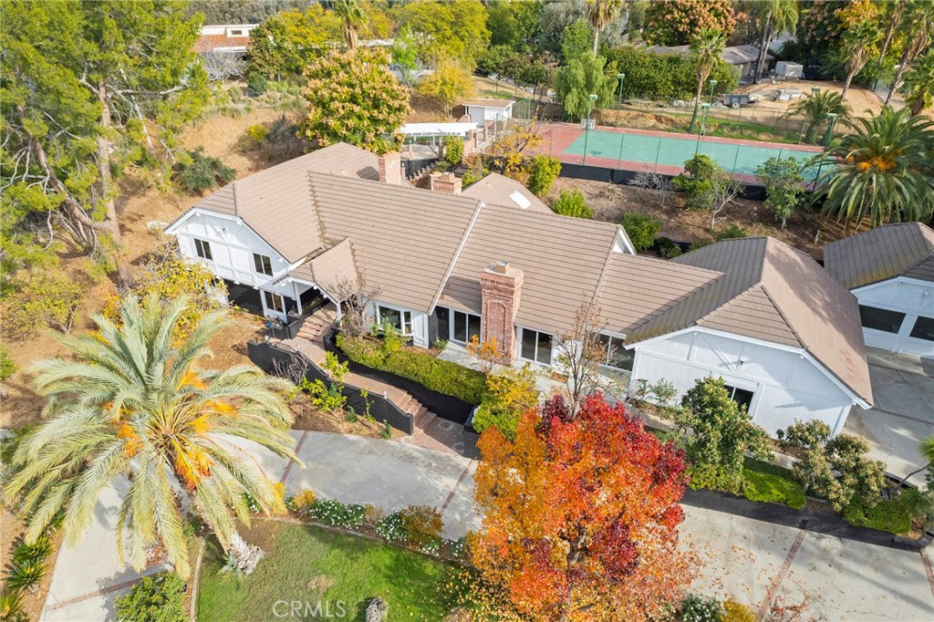 an aerial view of a house with a yard and potted plants