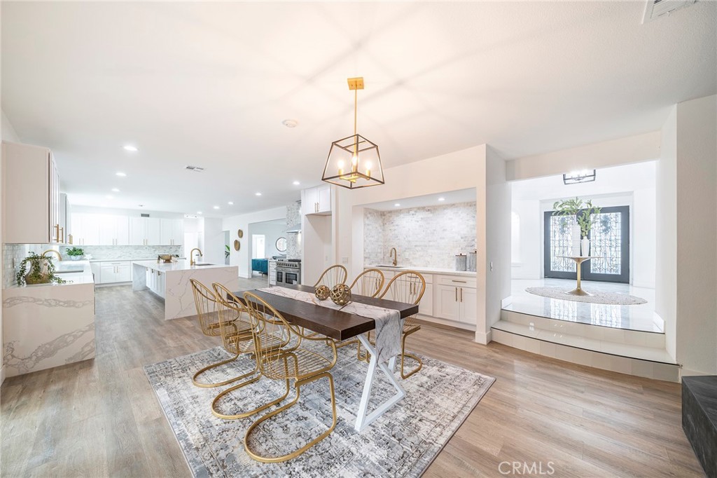 2225 Da Vinci Drive Riverside, CA 92506 - Photo 13 of 60 a view of a dining room with furniture wooden floor and a chandelier