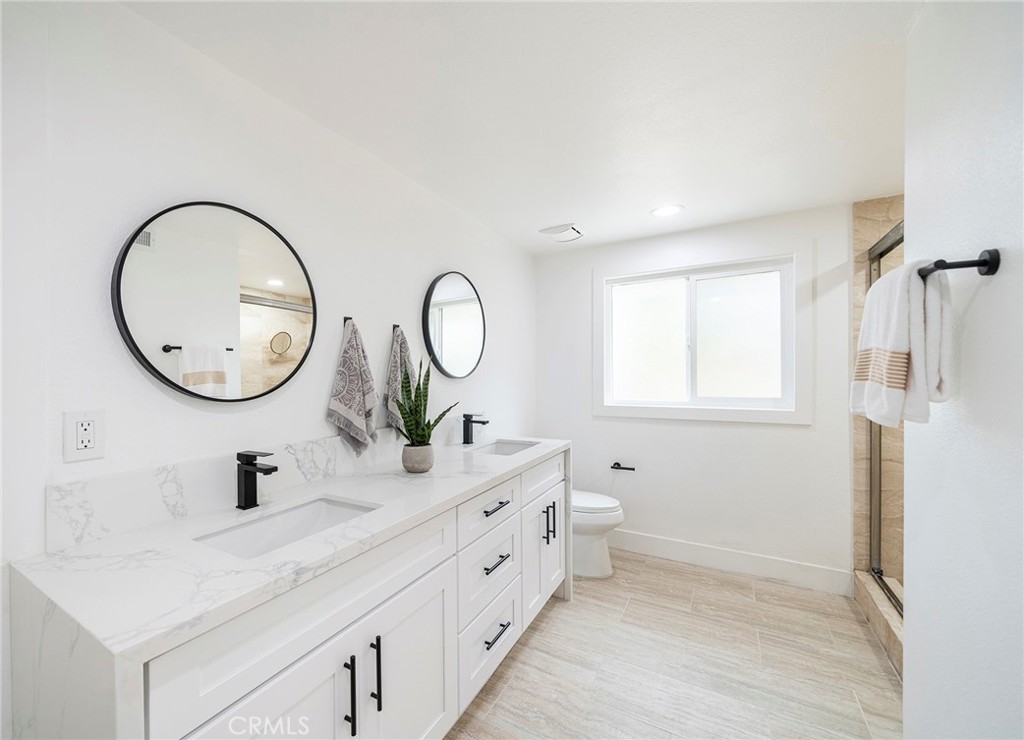 2225 Da Vinci Drive Riverside, CA 92506 - Photo 25 of 60 a bathroom with a double vanity sink mirror and a shower