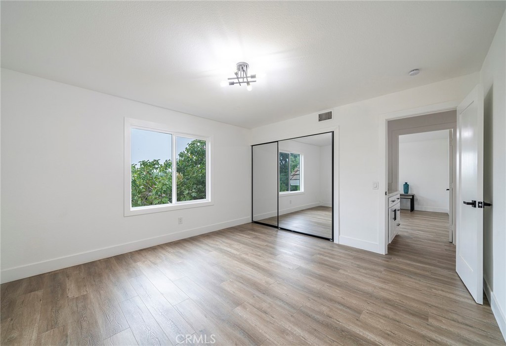 2225 Da Vinci Drive Riverside, CA 92506 - Photo 27 of 60 an empty room with wooden floor and windows