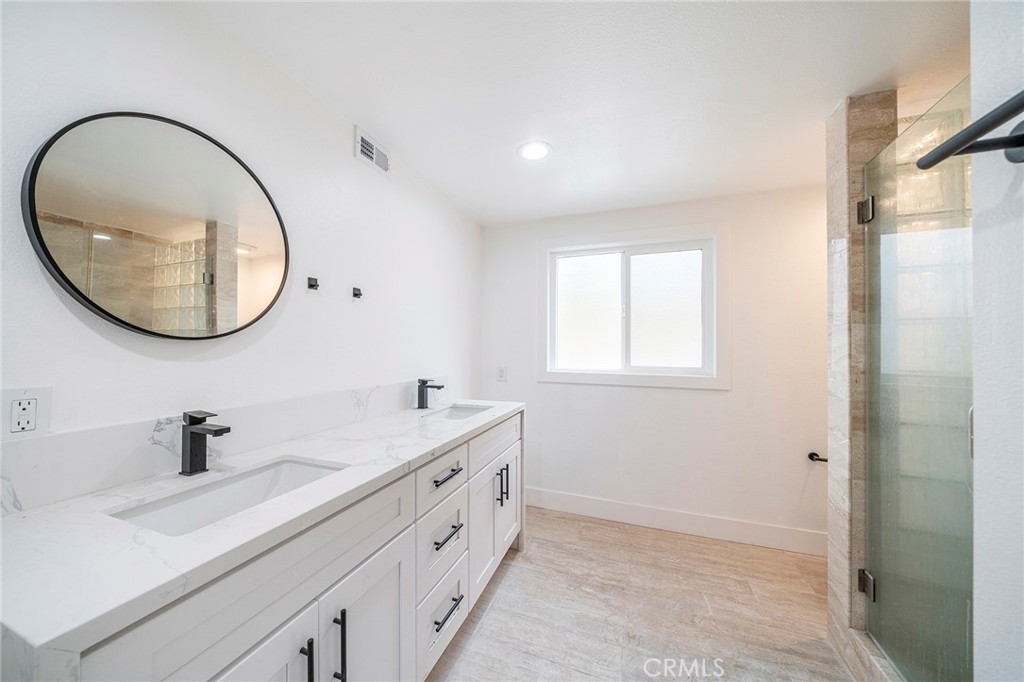2225 Da Vinci Drive Riverside, CA 92506 - Photo 28 of 60 a bathroom with a double vanity sink and a mirror