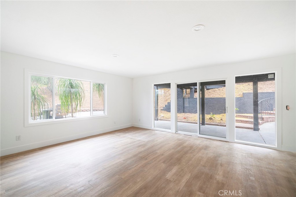 2225 Da Vinci Drive Riverside, CA 92506 - Photo 30 of 60 an empty room with wooden floor and windows