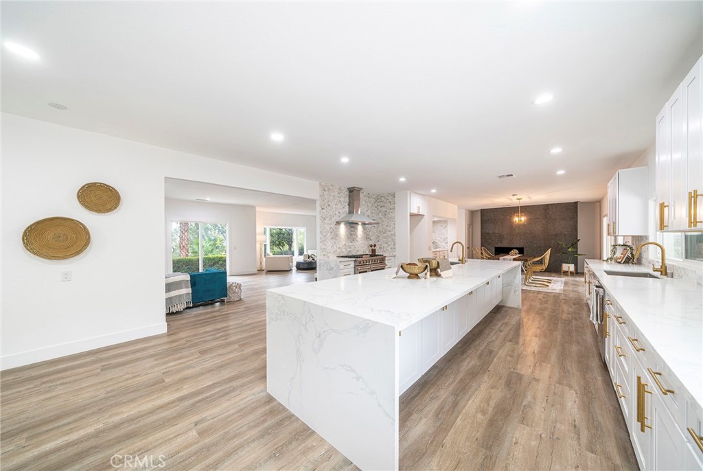 2225 Da Vinci Drive Riverside, CA 92506 - Photo 4 of 60 a large white kitchen with wooden floor and a sink