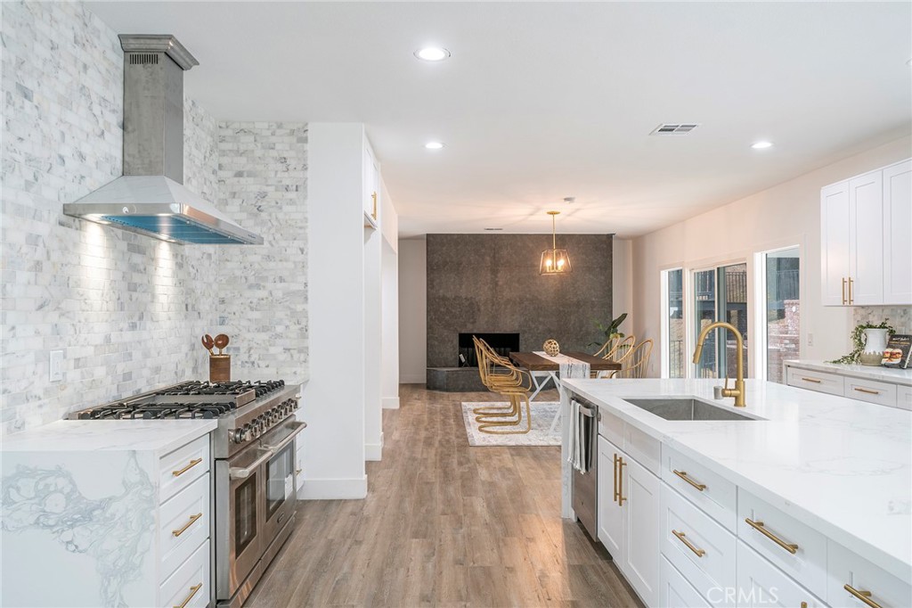 2225 Da Vinci Drive Riverside, CA 92506 - Photo 7 of 60 a large kitchen with a lot of counter space and a wooden floor