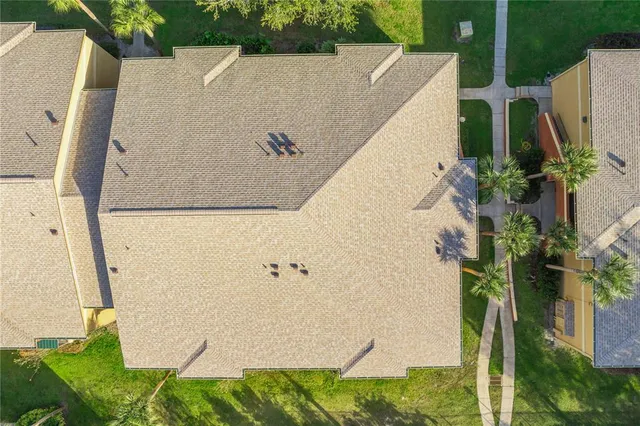 an aerial view of a house with a lake view