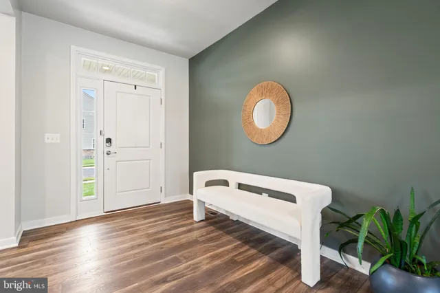 a living room with furniture and large windows