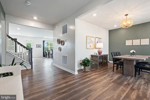 a view of an empty room with wooden floor and closet