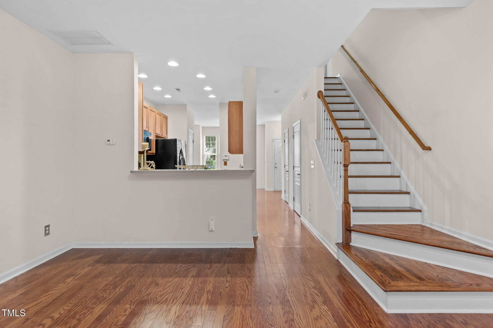 648 Cupola Drive Raleigh, NC 27603 - Photo 12 of 31 a view of a kitchen with wooden floor and stairs