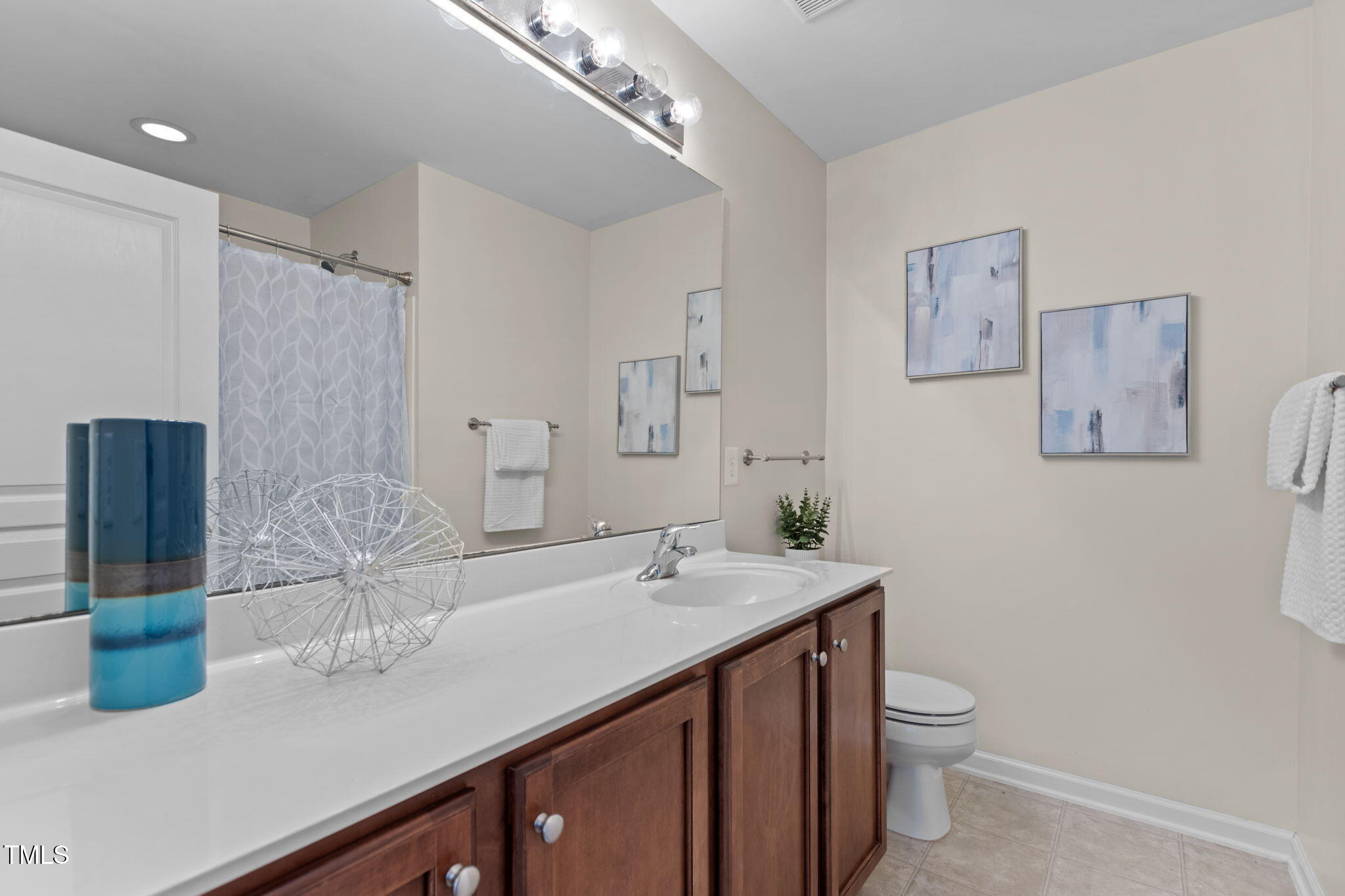648 Cupola Drive Raleigh, NC 27603 - Photo 17 of 31 a bathroom with a granite countertop sink a toilet and mirror