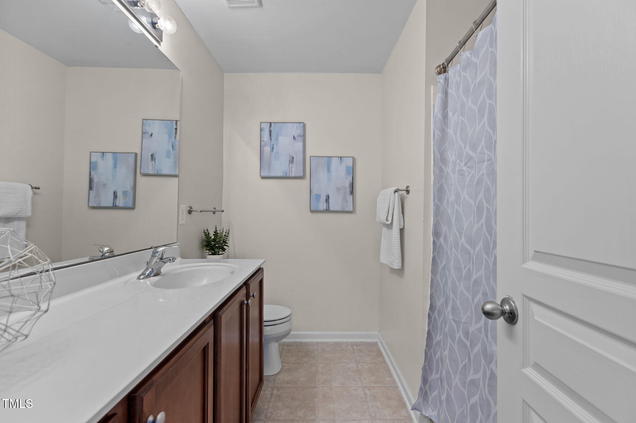648 Cupola Drive Raleigh, NC 27603 - Photo 18 of 31 a bathroom with a sink a toilet and shower