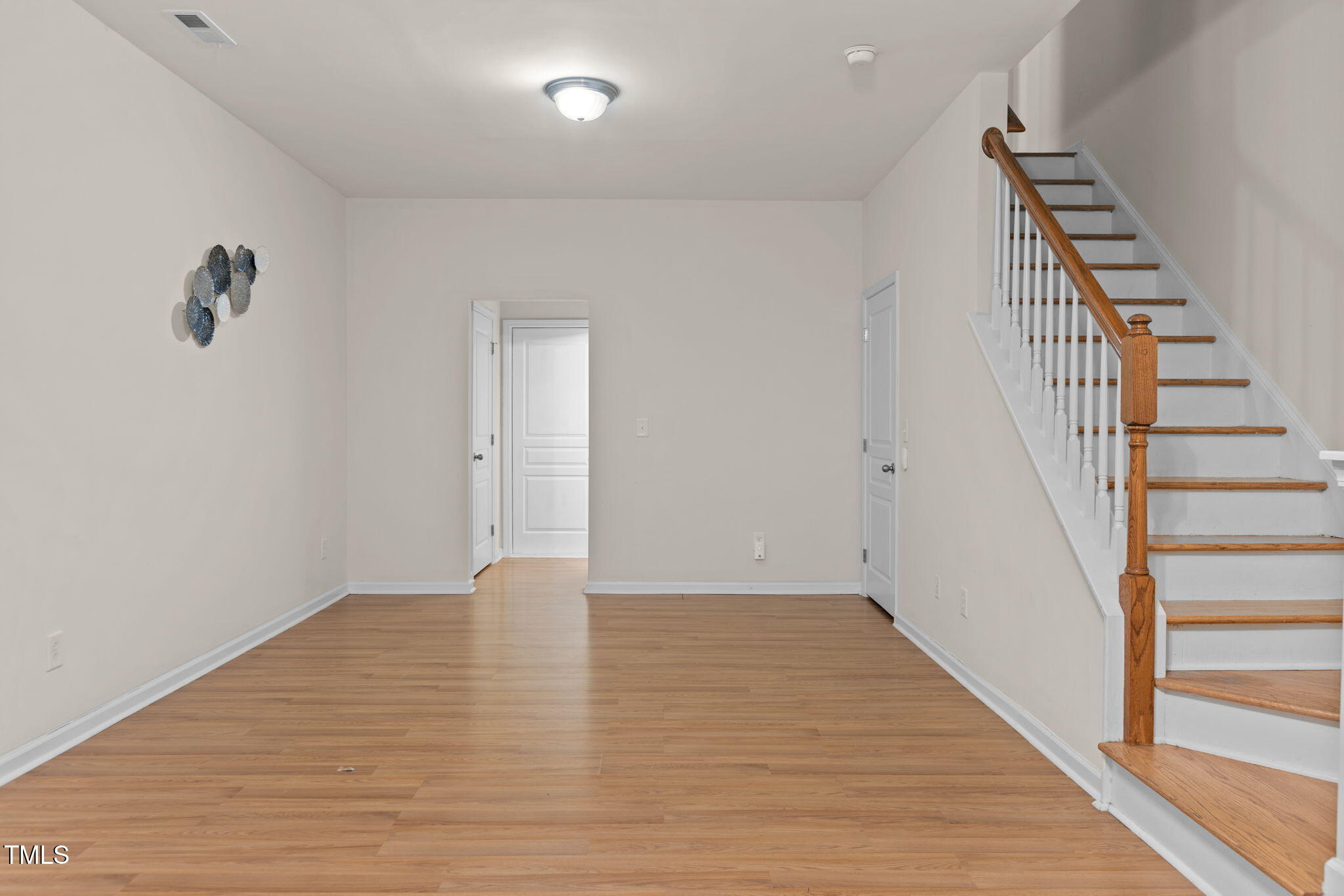648 Cupola Drive Raleigh, NC 27603 - Photo 23 of 31 a view of an empty room with wooden floor and stairs