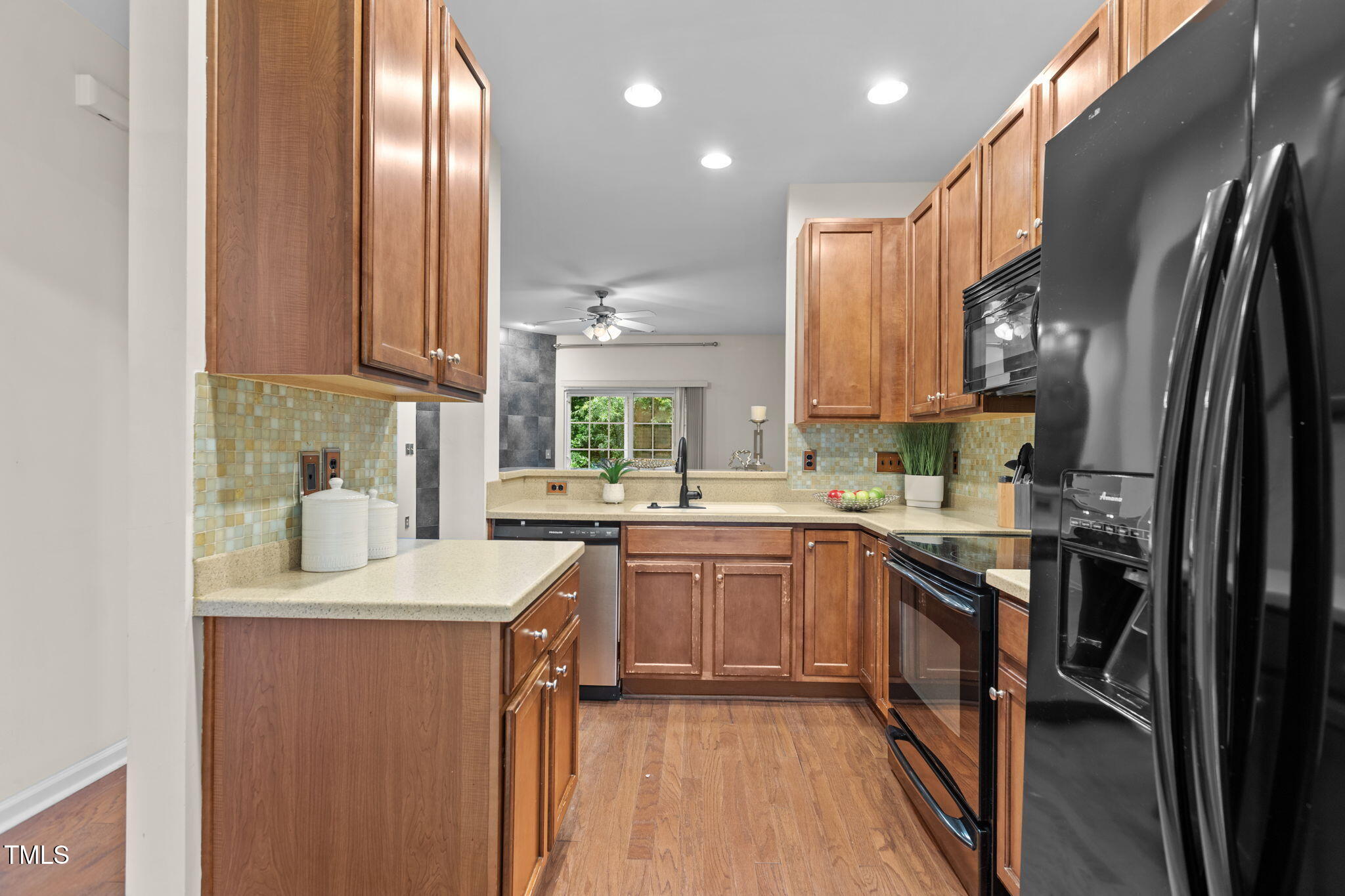 648 Cupola Drive Raleigh, NC 27603 - Photo 5 of 31 a kitchen with stainless steel appliances granite countertop a sink a stove and a refrigerator