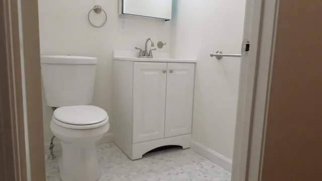 a bathroom with a toilet a sink and vanity
