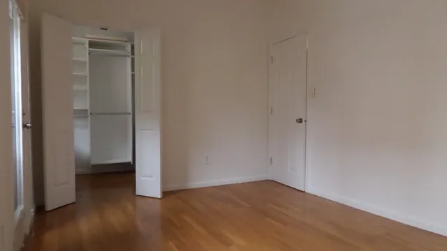 a view of an empty room and closet area