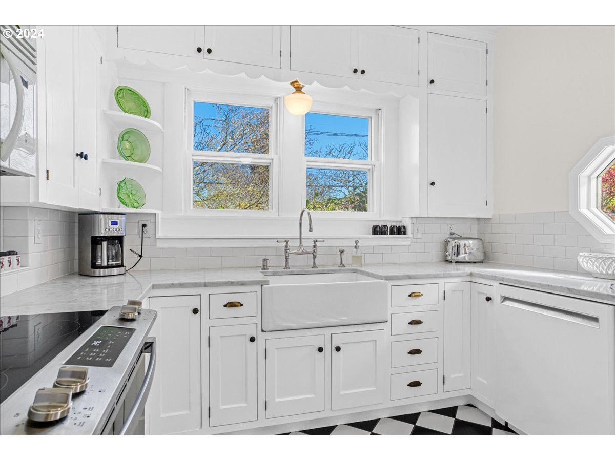 3752 Southeast Alder Street Portland, OR 97214 - Photo 13 of 44 a kitchen with cabinets appliances a sink and a window