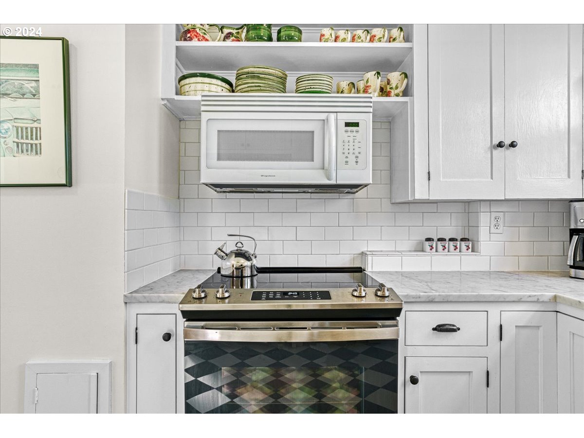 3752 Southeast Alder Street Portland, OR 97214 - Photo 15 of 44 a kitchen with stove and cabinets